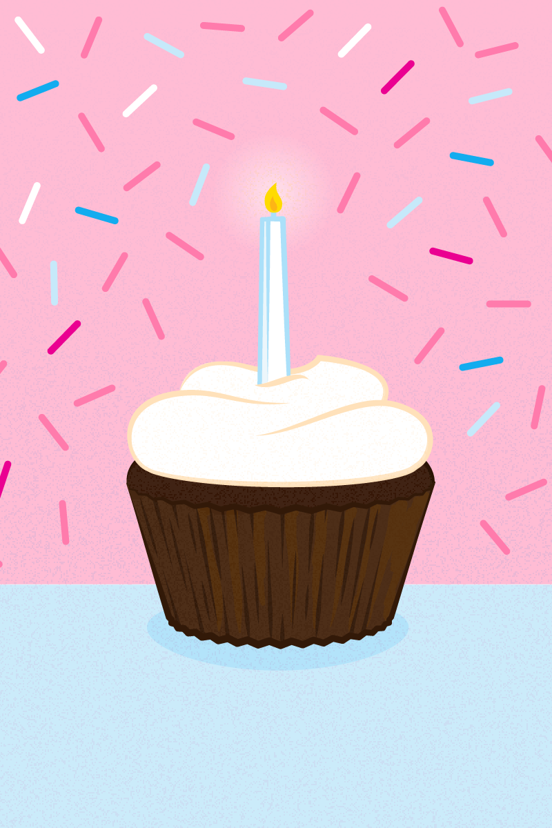 a cupcake with a lit birthday candle and confetti